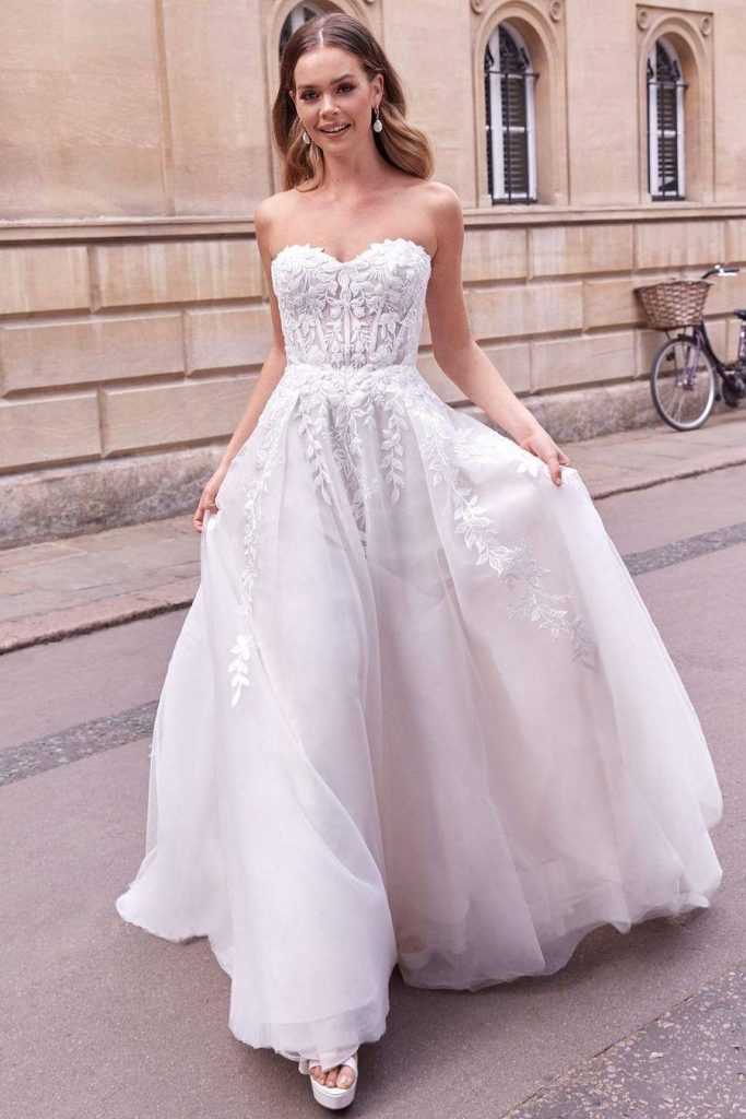 Strapless ball gown with sweetheart neckline and trailing leaf lace over tulle