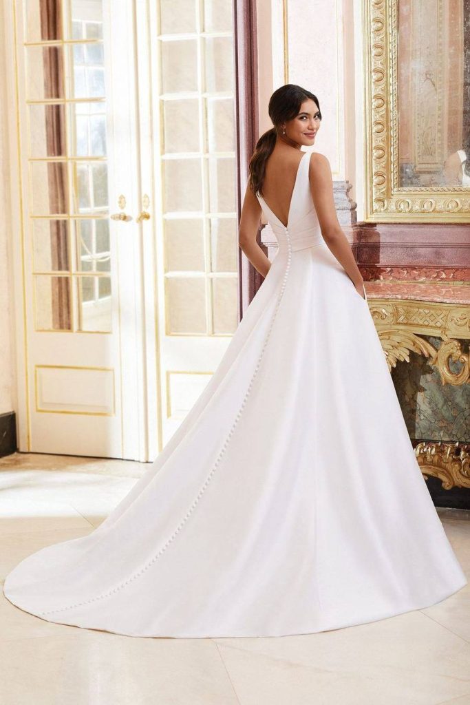 Back view of a V-neck mikado ball gown with a covered button placket down the train