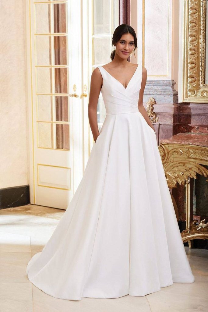 Sleeveless V-neck mikado ball gown with pleated bodice and side pockets
